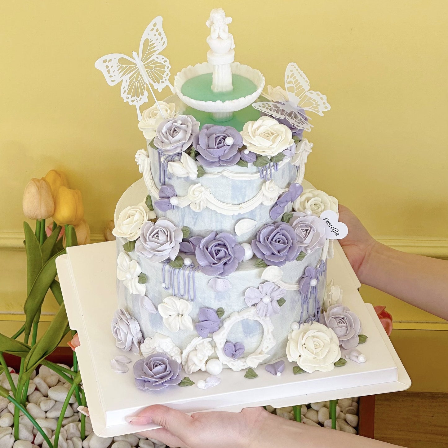 Purple floral two tier wishing fountain cake