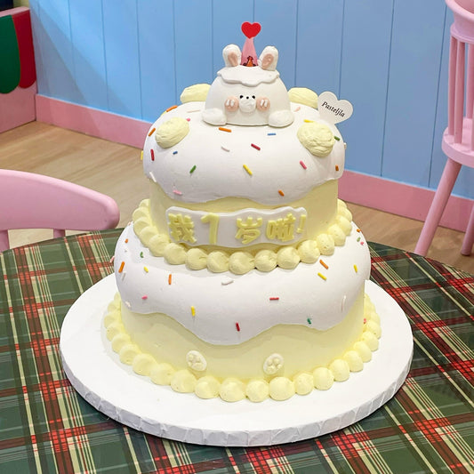 Two tier yellow theme bunny cake