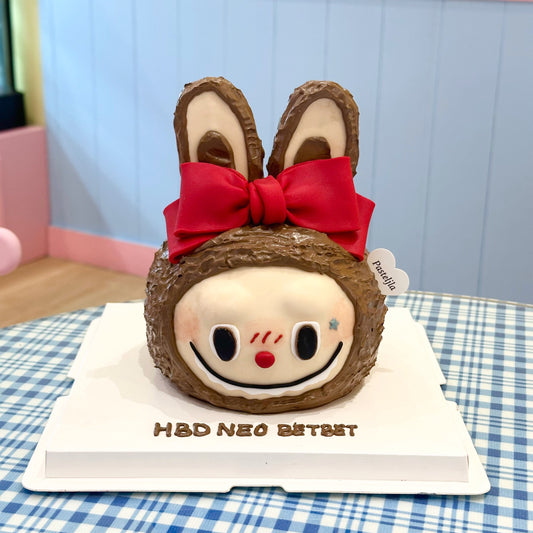 Labubu head with red ribbon cake