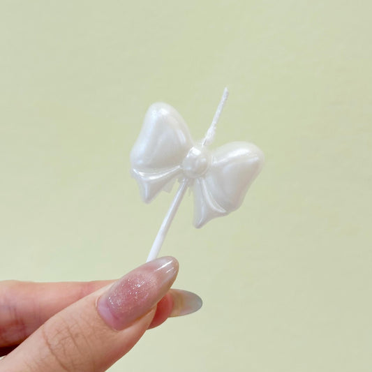 White ribbon candle